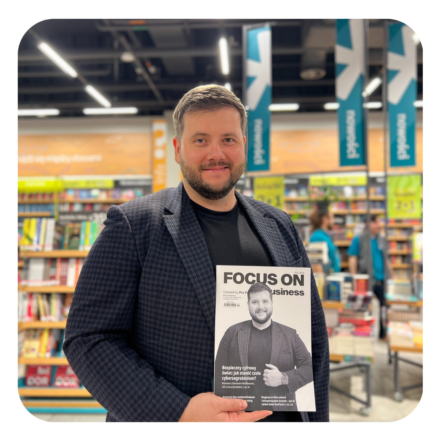 Interview in a bookstore — expert holding a copy of FOCUS ON Business magazine