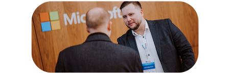 Handshake with Microsoft logo in the background