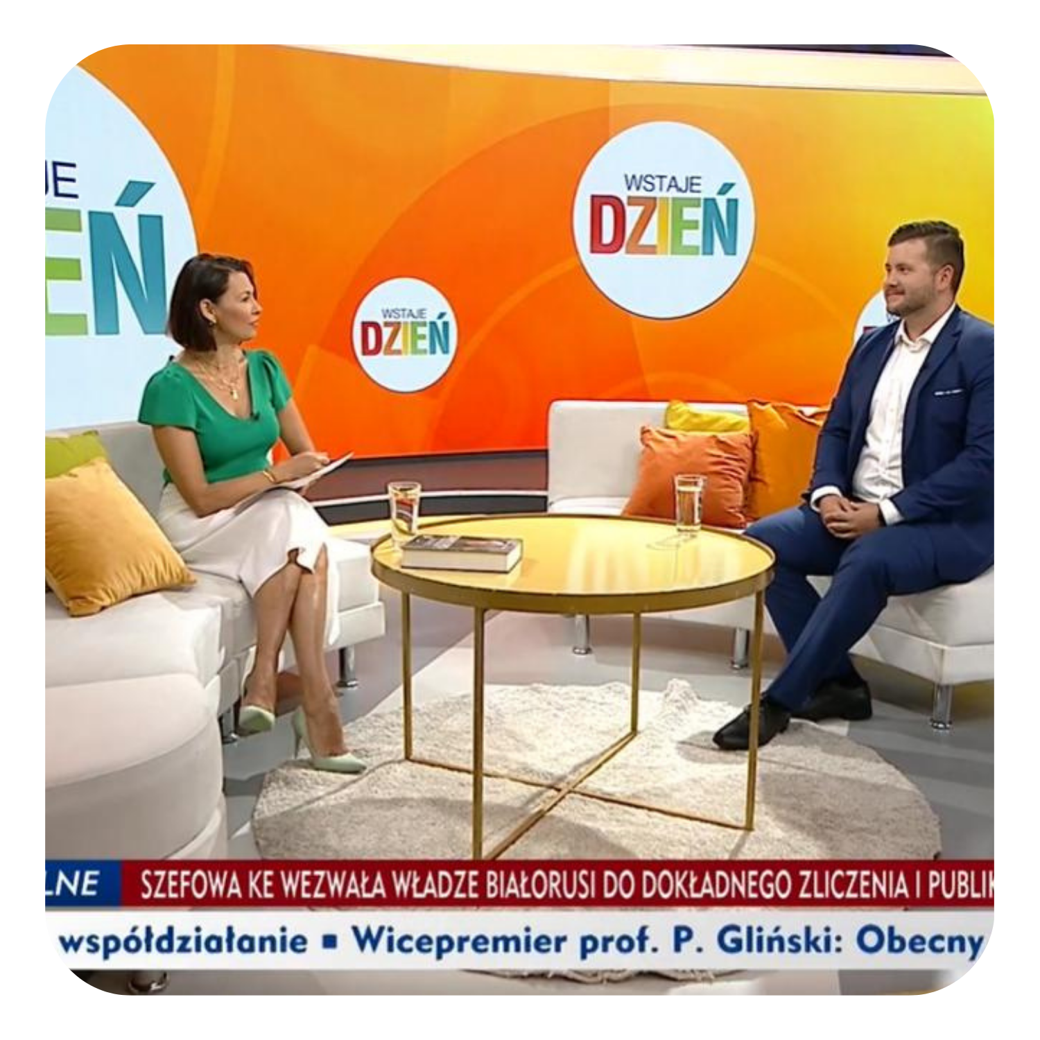 Interview in a morning TV show studio — IT expert talking with the host