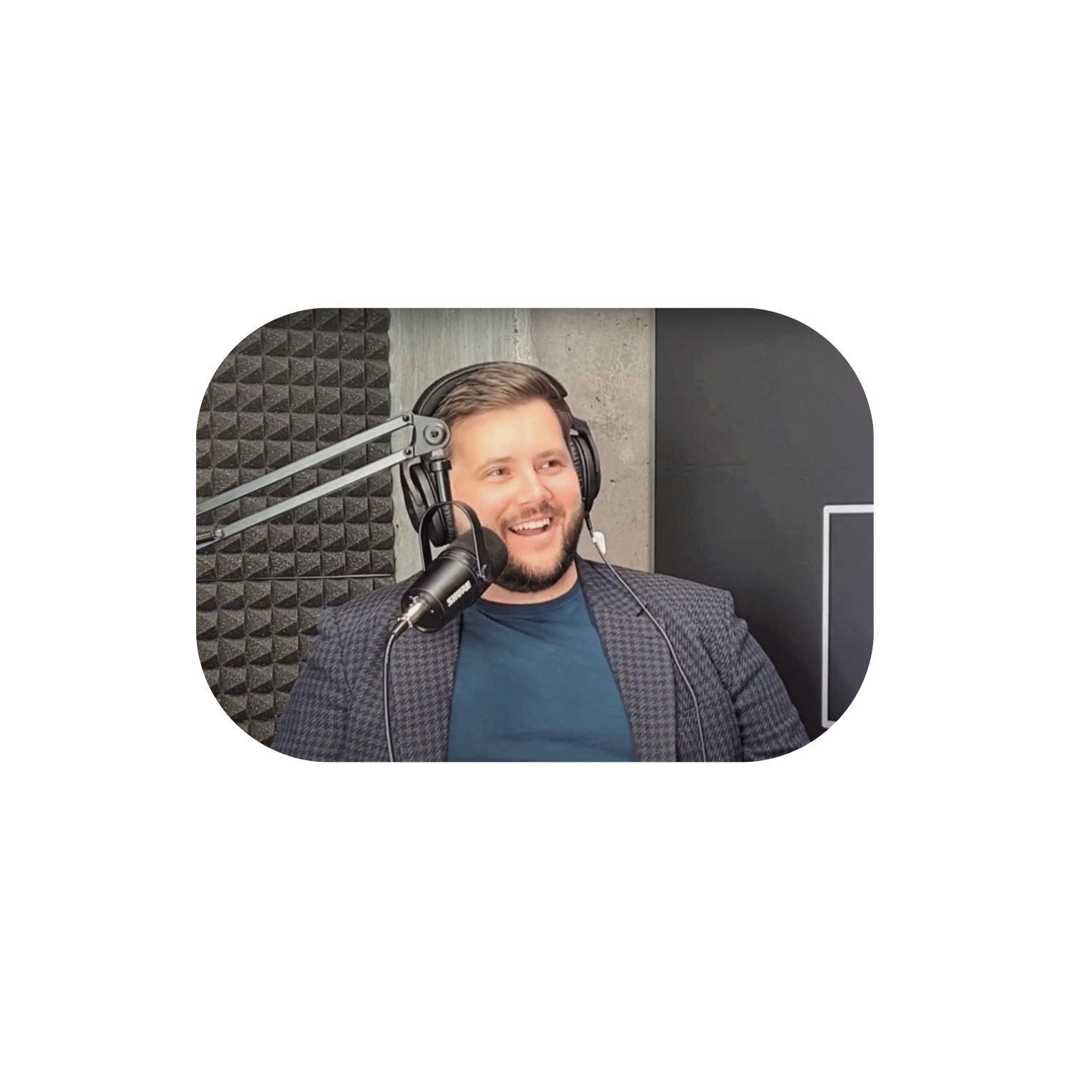Podcast recording — host wearing headphones at a microphone in a studio
